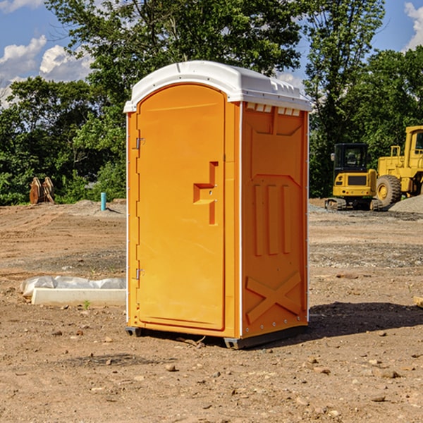 what is the cost difference between standard and deluxe porta potty rentals in Gilman City